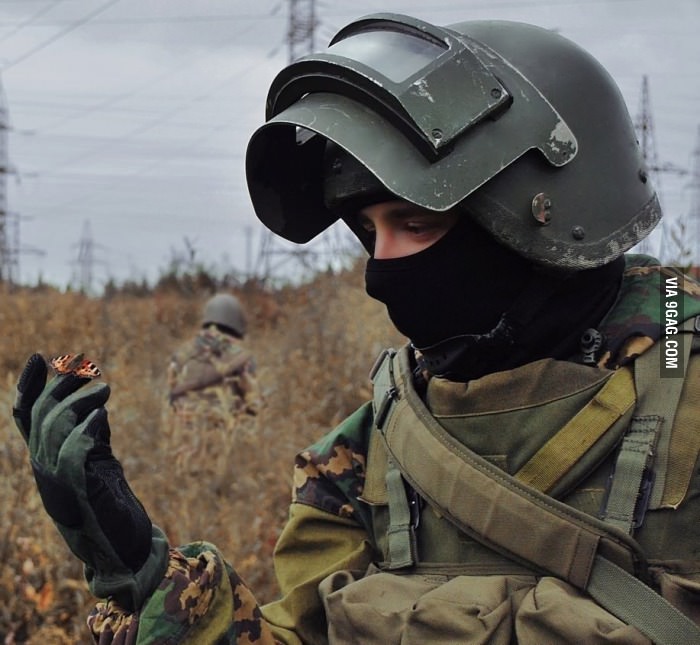 Russian spetsnaz operative with a butterfly perched on his fingertip