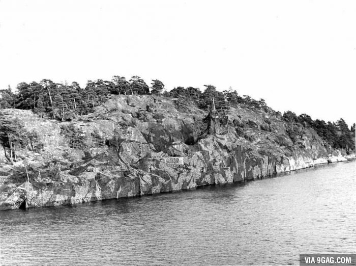 Heavily camouflaged Swedish battleship next to land?