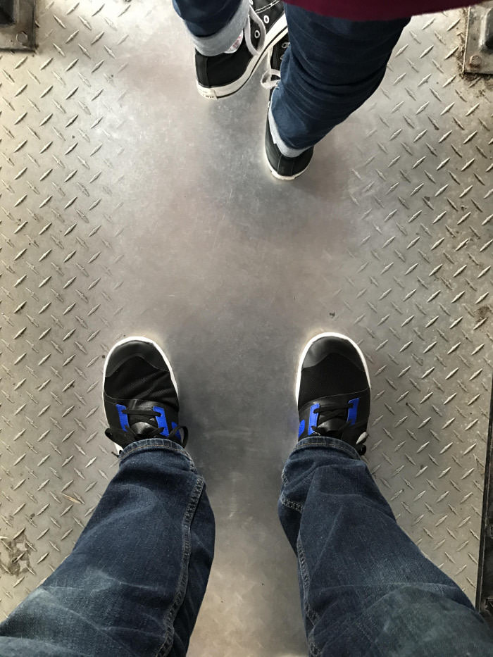 Diamond steel plate worn smooth by shoes at amusement park.