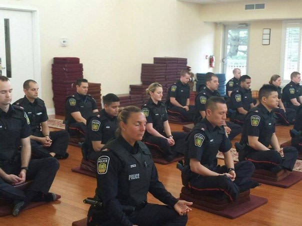 These Canadian police service members meditate at the beginning of their shift