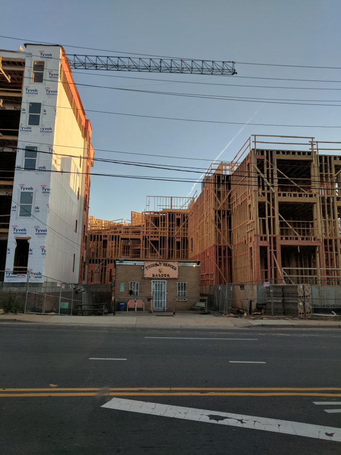 This saloon refused to sell their property to an apartment company and now the apartment has to build around them.